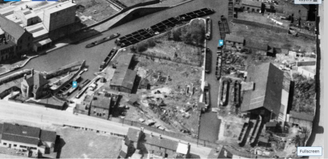 A more general shot of the yard, the dock is front right. Empty boats awaiting orders or docking can be seen moored on the main line with a loaded boat heading for Birchills top lock to work its way down towards Pleck and maybe beyond.